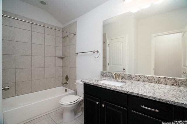 full bathroom with tiled shower / bath, vaulted ceiling, tile patterned flooring, vanity, and toilet