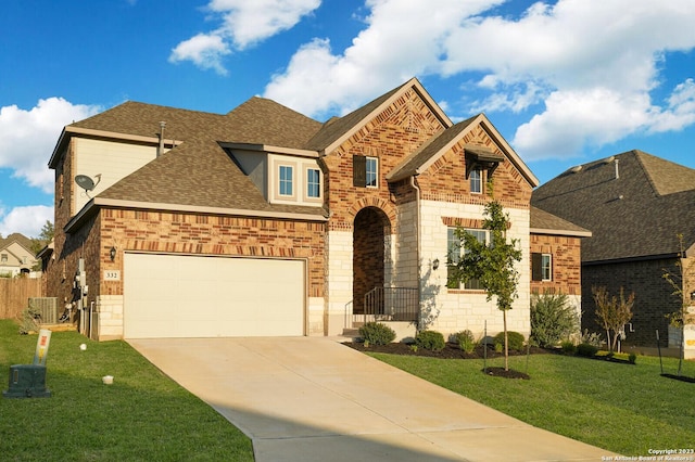 view of front of house featuring a garage, central AC, and a front yard