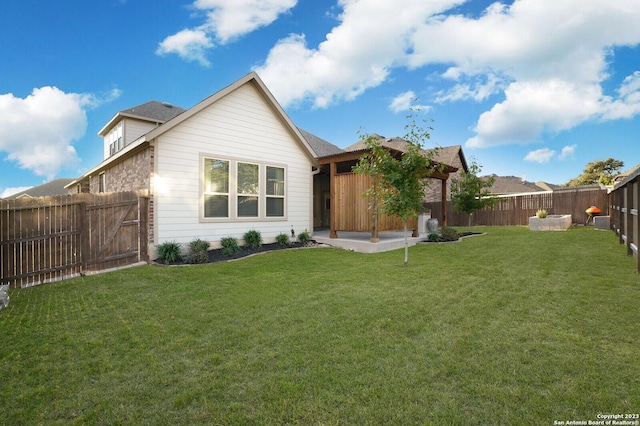 rear view of property with a yard