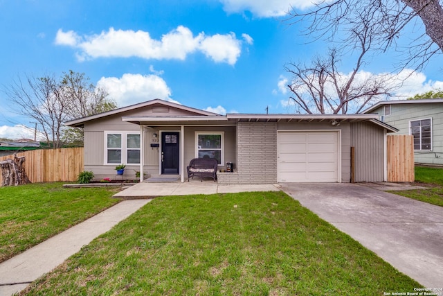 ranch-style home with a garage and a front yard