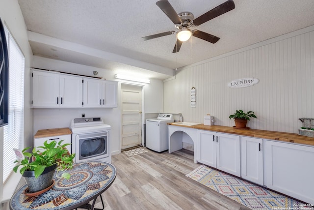 clothes washing area with washer / clothes dryer, light hardwood / wood-style floors, a textured ceiling, and ceiling fan