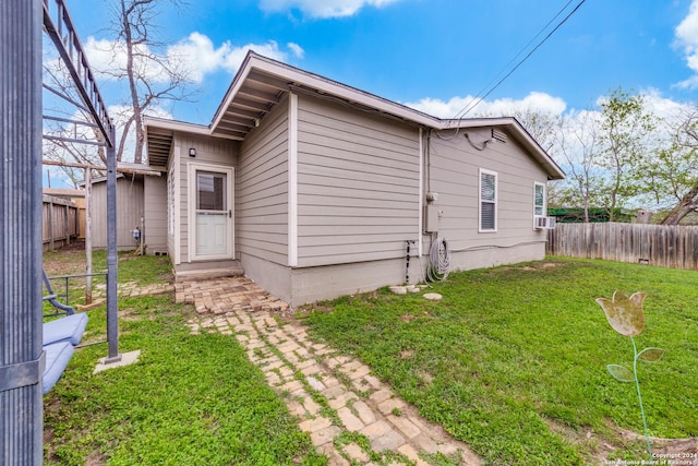 view of side of home featuring a yard