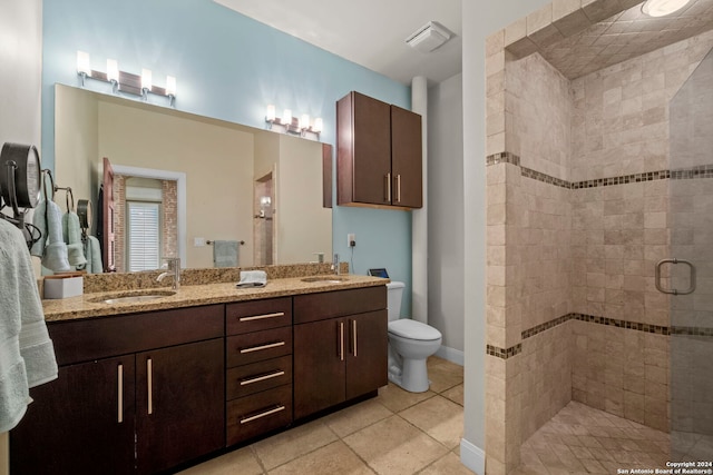 bathroom with vanity, toilet, and an enclosed shower