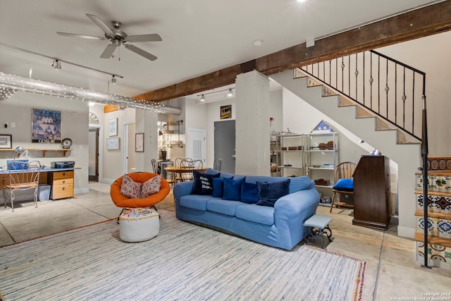 living room with ceiling fan and beamed ceiling