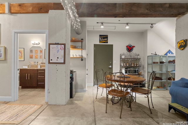 dining space featuring rail lighting