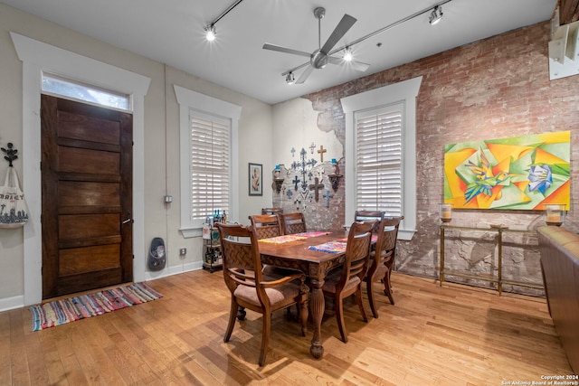 dining space featuring ceiling fan, rail lighting, and light hardwood / wood-style flooring