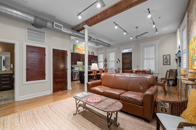 living room with ceiling fan, track lighting, and light hardwood / wood-style floors