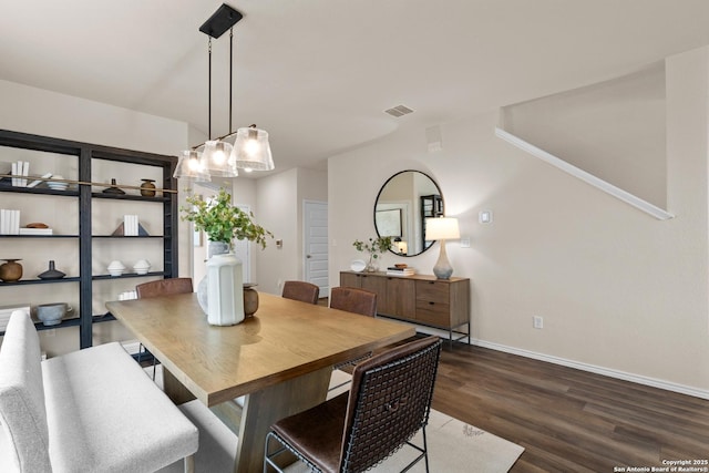 dining area featuring dark wood-type flooring