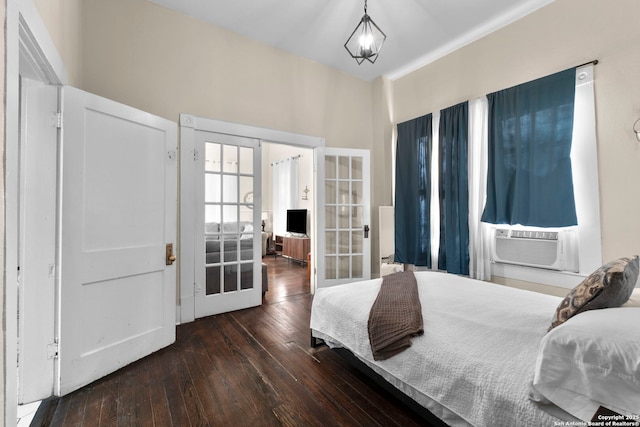 bedroom featuring cooling unit, dark wood-type flooring, and french doors