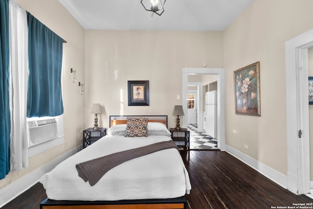 bedroom featuring white refrigerator, dark hardwood / wood-style floors, and cooling unit