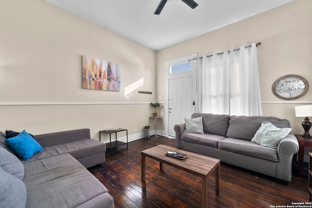 living room featuring dark wood-type flooring and ceiling fan