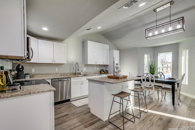 kitchen featuring decorative light fixtures, sink, white cabinets, a center island, and stainless steel appliances