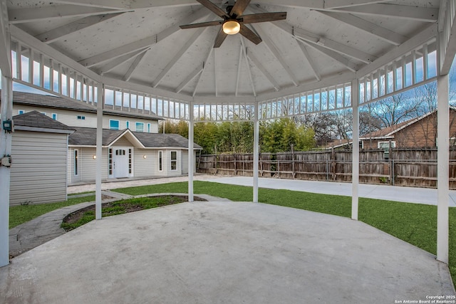 unfurnished sunroom featuring vaulted ceiling with beams