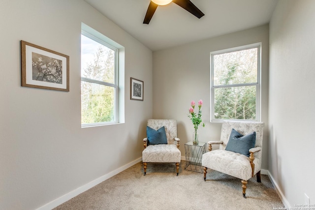 sitting room featuring ceiling fan and carpet