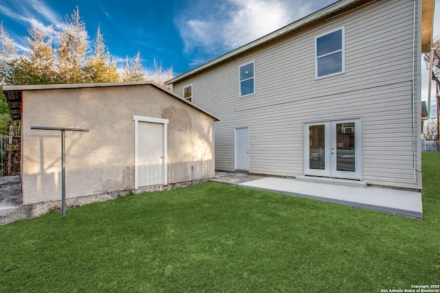 rear view of house with a yard, a patio area, and french doors