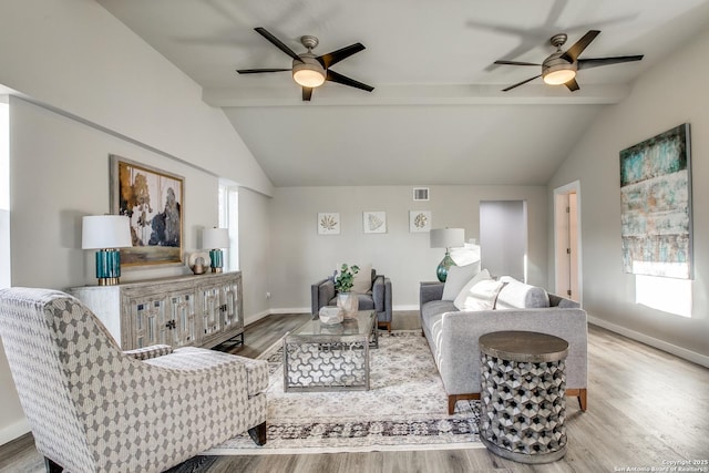 living room featuring light hardwood / wood-style flooring, lofted ceiling with beams, and ceiling fan