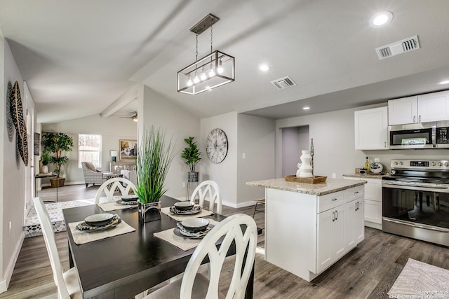 kitchen with pendant lighting, stainless steel appliances, light stone countertops, white cabinets, and a kitchen island