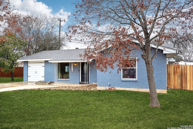 view of front of house with a garage and a front lawn