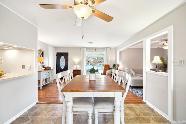 dining space featuring tile patterned flooring and ceiling fan