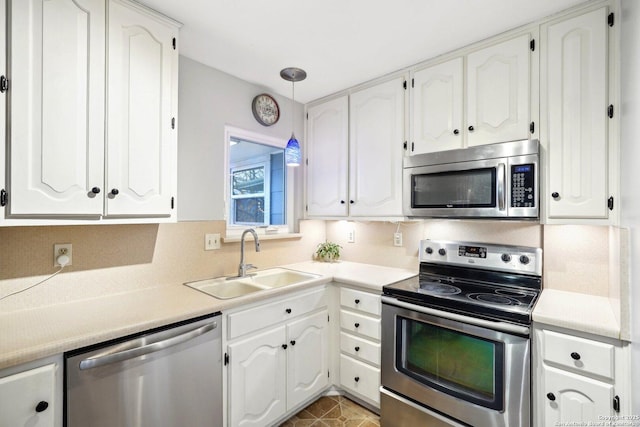 kitchen featuring white cabinetry, sink, and appliances with stainless steel finishes