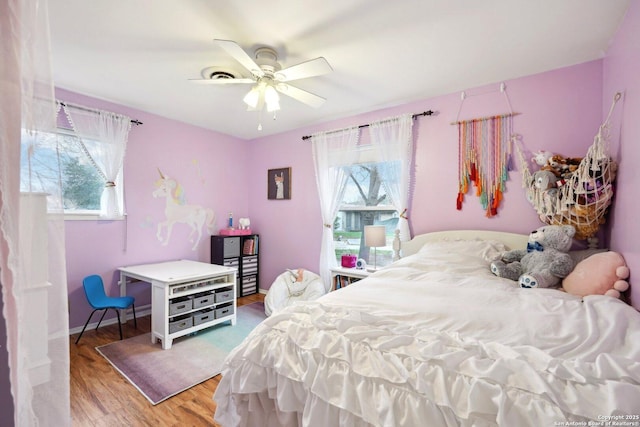 bedroom with hardwood / wood-style flooring and ceiling fan