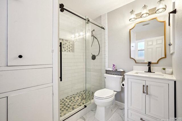 bathroom featuring vanity, toilet, and walk in shower