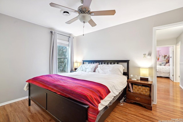 bedroom with wood-type flooring and ceiling fan