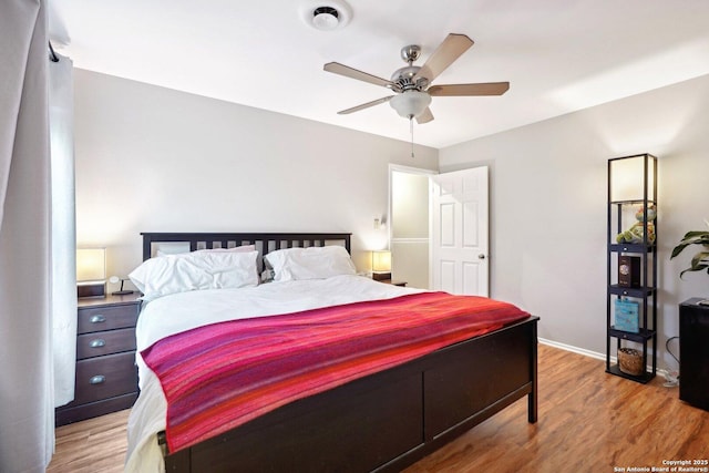 bedroom with hardwood / wood-style floors and ceiling fan