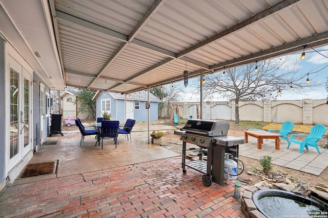 view of patio / terrace with grilling area and a shed