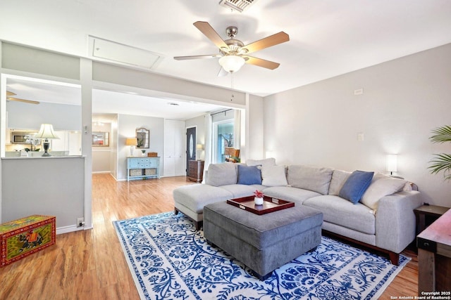 living room featuring hardwood / wood-style flooring and ceiling fan