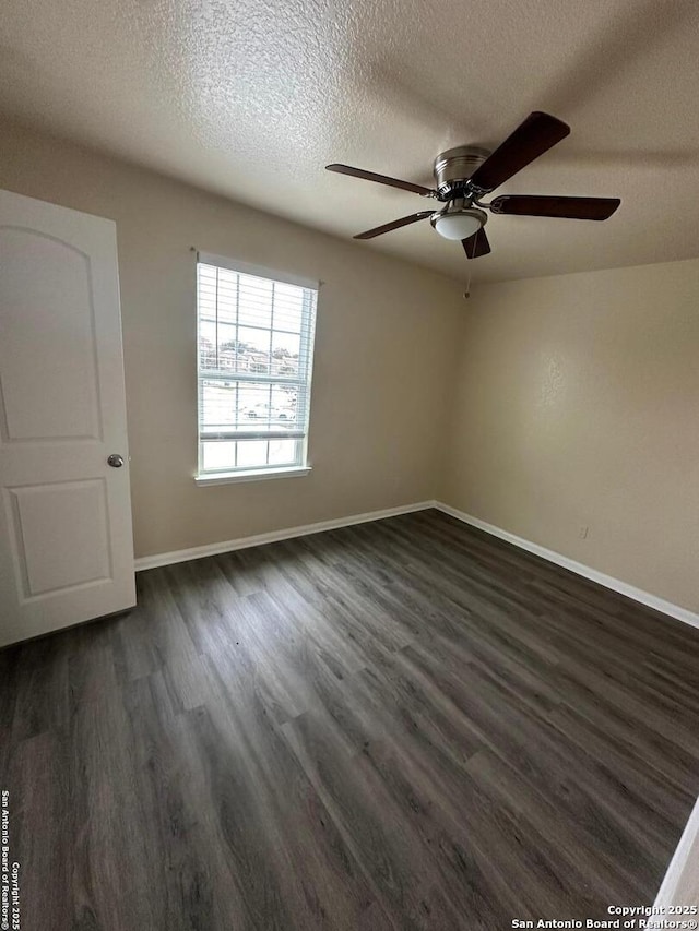 unfurnished room with dark hardwood / wood-style flooring, ceiling fan, and a textured ceiling