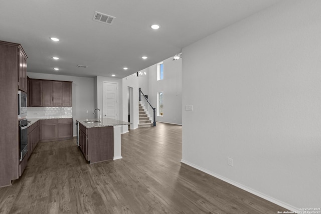 2439 Tinkerton, San Antonio, TX 78245 - kitchen with stainless steel microwave, a sink, recessed lighting, a center island with sink, and oven