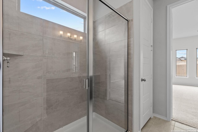 2439 Tinkerton, San Antonio, TX 78245 - bathroom featuring healthy amount of natural light, a stall shower, tile patterned floors, and baseboards