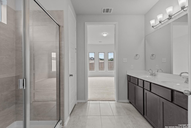 2439 Tinkerton, San Antonio, TX 78245 - bathroom with double vanity, a stall shower, tile patterned flooring, and baseboards