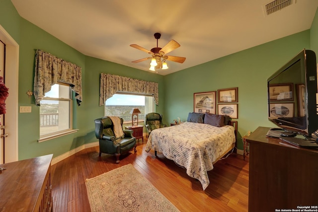 bedroom with hardwood / wood-style floors and ceiling fan