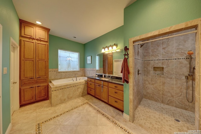 bathroom with plus walk in shower, vanity, and tile patterned floors