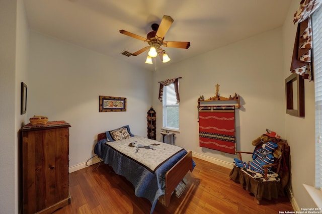 bedroom with wood-type flooring and ceiling fan