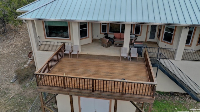 wooden deck featuring an outdoor hangout area and a patio area