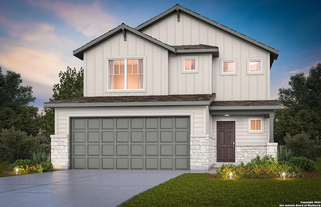 view of front of property with a garage and a lawn