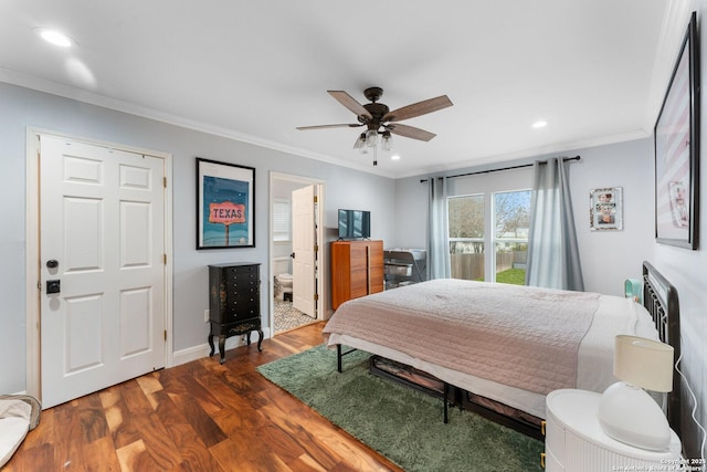 bedroom with crown molding, dark hardwood / wood-style floors, ceiling fan, and ensuite bath