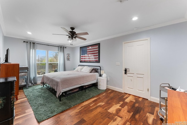 bedroom with ornamental molding, ceiling fan, and dark hardwood / wood-style flooring