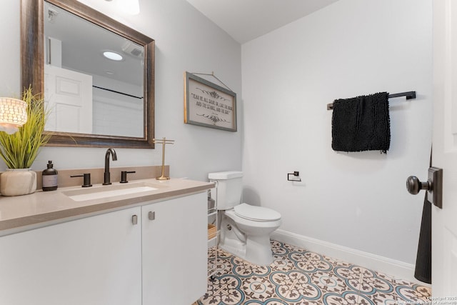 bathroom featuring vanity, toilet, and tile patterned flooring