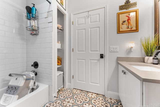 bathroom featuring tiled shower / bath, tile patterned floors, and vanity