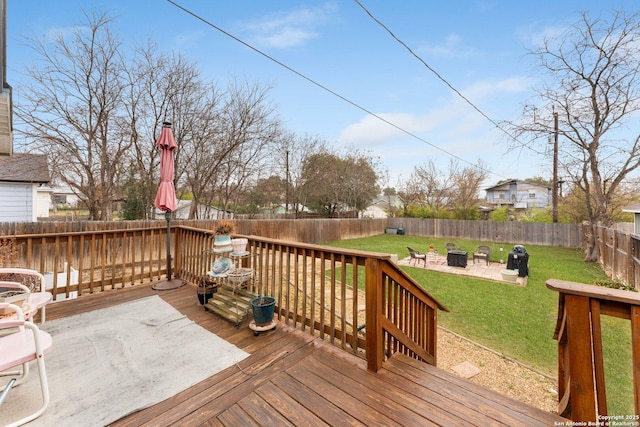 wooden terrace featuring an outdoor fire pit, a yard, and a patio