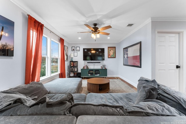 living room featuring ornamental molding, hardwood / wood-style floors, and ceiling fan