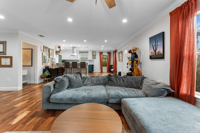 living room featuring hardwood / wood-style floors and crown molding