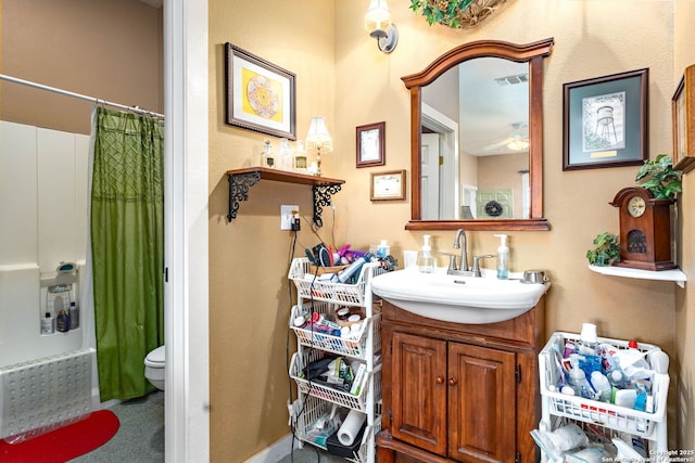 full bathroom featuring vanity, toilet, and shower / tub combo with curtain