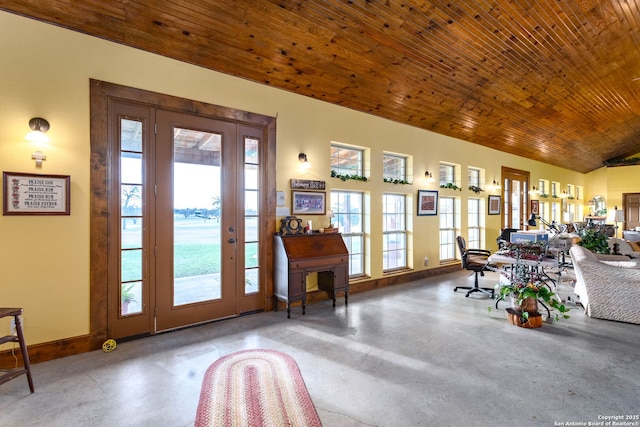 foyer entrance with lofted ceiling, concrete floors, and wood ceiling