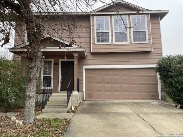 traditional home featuring a garage and driveway