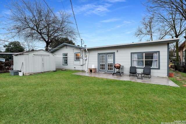 rear view of house with a storage unit, a patio, and a lawn